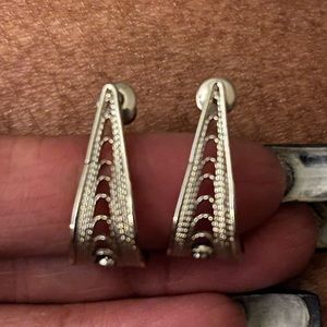 Beautiful silver tone J style earrings with open work